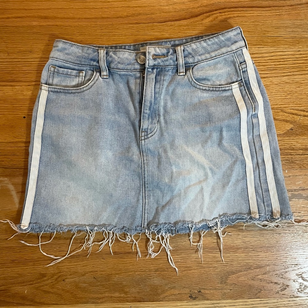 Pacsun size 25 denim skirt with thin white stripes on the side.
